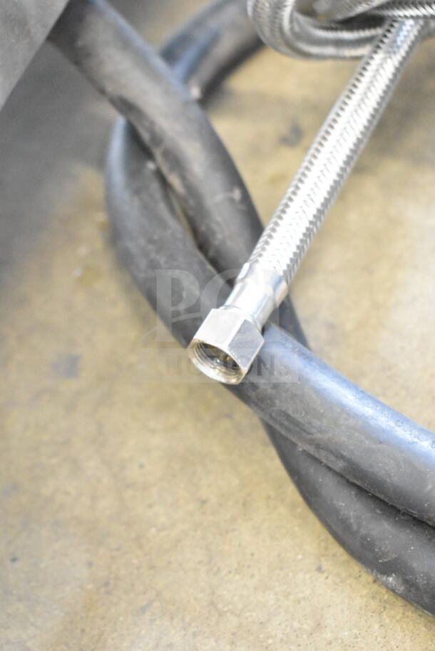 Close-up of a flexible metal hose and rubber cable for a Fetco CBS-2052e20 Coffee Machine. Suitable for commercial use.