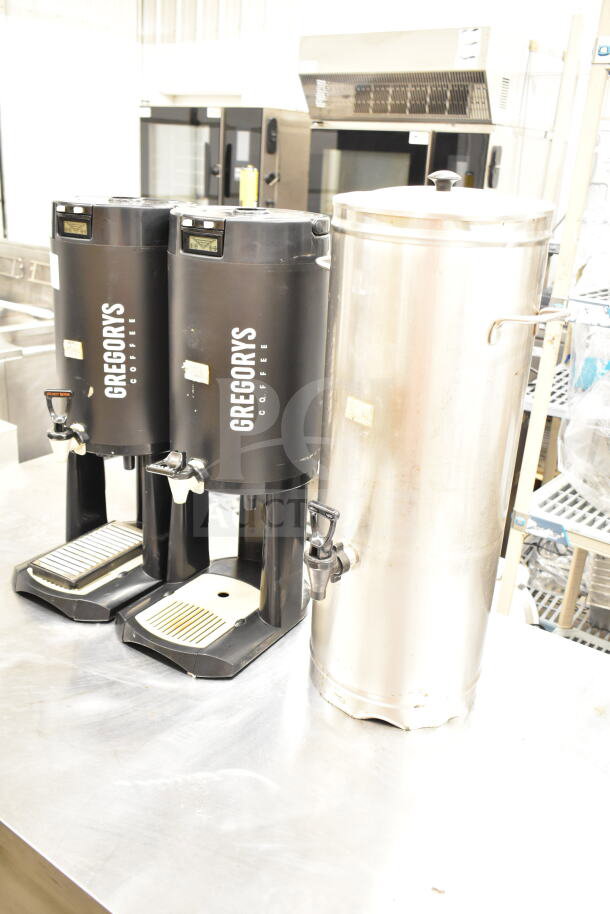 Three satellite beverage servers, including Gregorys Coffee branded units and one stainless steel model. Slight wear visible.