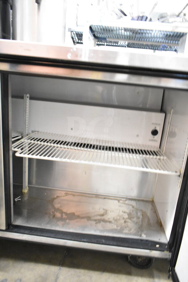 True Commercial 2 Door Undercounter Cooler, 115 volts, 1 phase. Features white wire shelving, stainless steel interior, used condition.