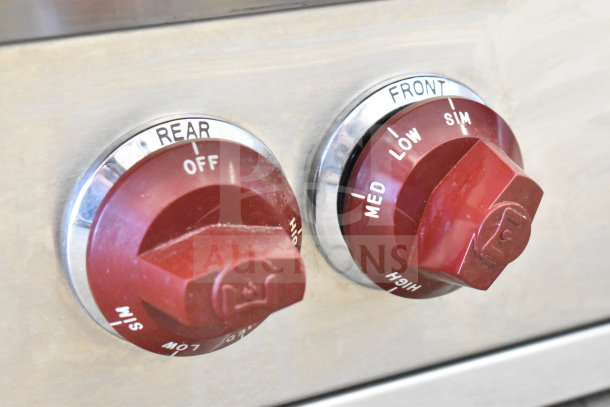 Red control knobs on Wolf Commercial Countertop Gas 8 Burner Range, showing settings for rear and front burners.