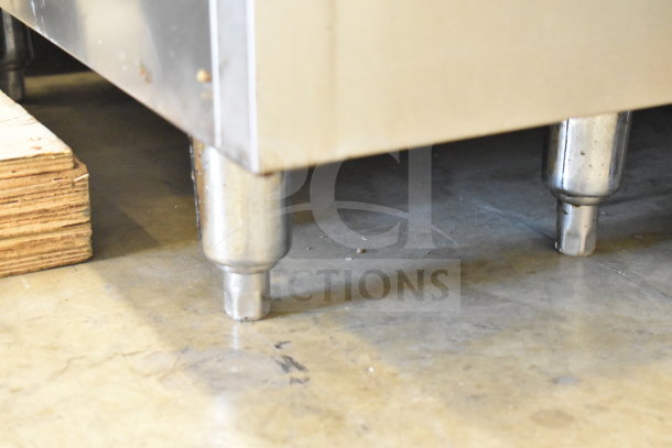 Bakers Pride gas-powered commercial deep fat fryer, floor style. Stainless steel frame, sturdy legs, used condition.