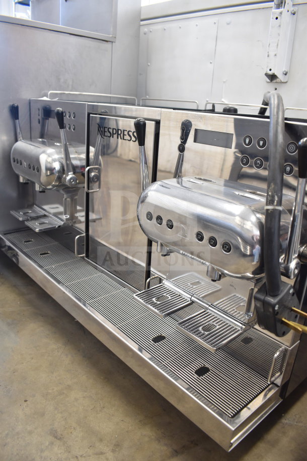 Nespresso Aguila 420 commercial espresso machine, stainless steel, dual dispenser, pristine condition, sleek design.