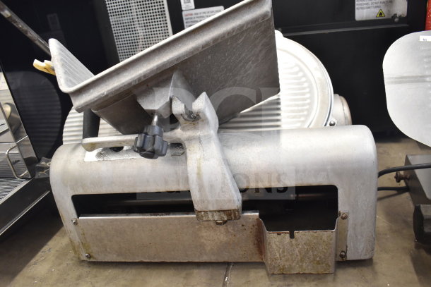 Commercial countertop meat slicer, stainless steel, 115 volts, 1 phase, used condition, visible wear and rust.