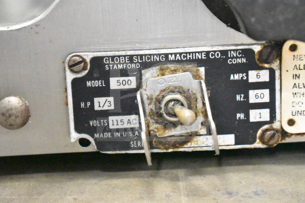 Globe 500 Commercial Meat Slicer, 115V, 1-phase; features blade sharpener; model plate details visible.