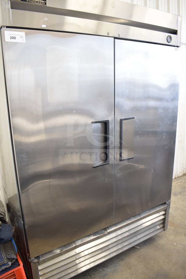 True T-49F commercial 2-door reach-in freezer on casters, stainless steel, 115 volts, 1 phase, slight wear visible.