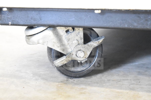 True T-49F commercial freezer caster. Metal and rubber construction, shows slight wear, part of mobility system.