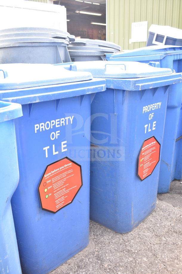 Set of 3 blue poly trash cans with "Property of TLE" marking. Features red information label. Good condition. Auction bid applies to all.