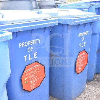 Set of 3 blue poly trash cans with "Property of TLE" marking. Features red information label. Good condition. Auction bid applies to all.