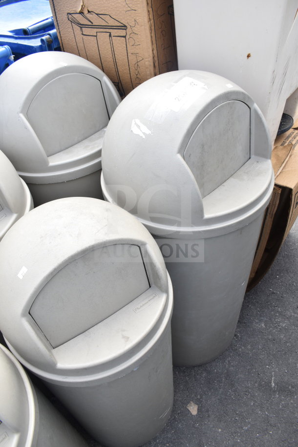 Three tan Rubbermaid poly trash cans with dome lids, slight wear, labels on lids. Auction: 3 times your bid.