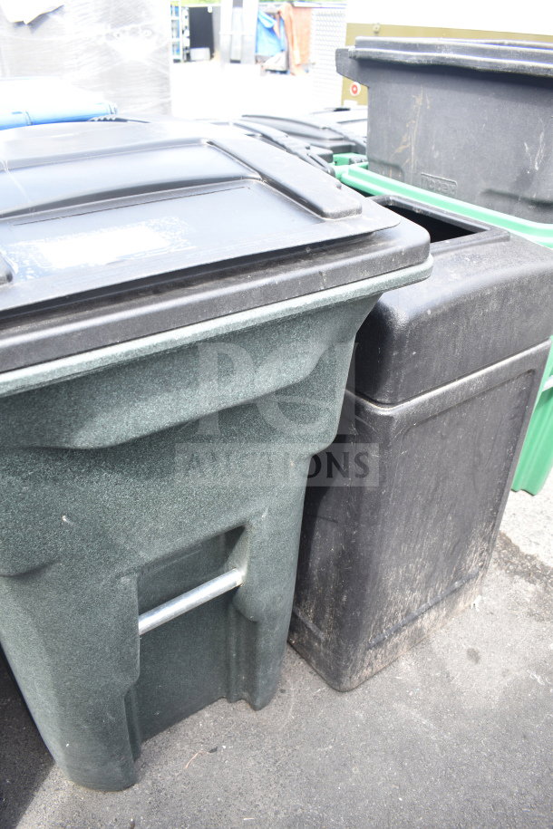 Two poly trash cans, one green and one black, with lids; used condition. Durable, suitable for outdoor use.