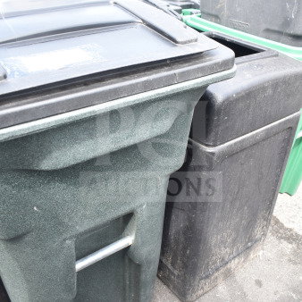 Two poly trash cans, one green and one black, with lids; used condition. Durable, suitable for outdoor use.