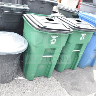 Four poly trash cans, varying colors, including green for plastics. Used condition, sturdy build, labeled for "Plastics Only."