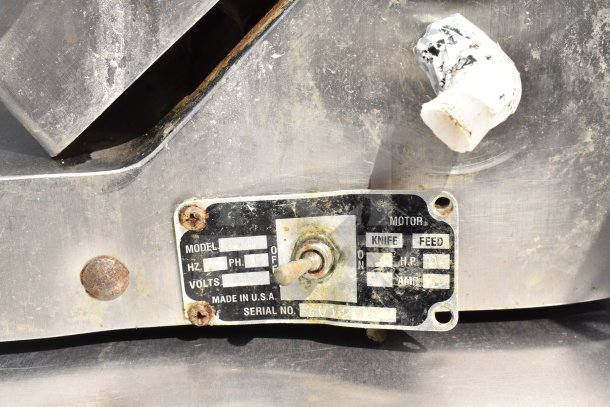 Globe 300 Commercial Meat Slicer with blade sharpener, showing model plate details. 115 Volts, 1 Phase, Made in USA.