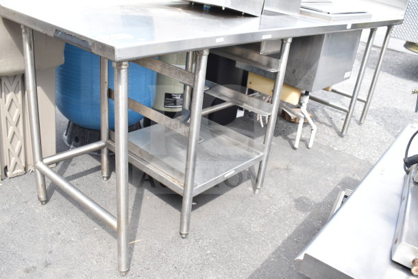 Commercial stainless steel table with integrated ice bin, durable construction, used condition, suitable for catering needs.
