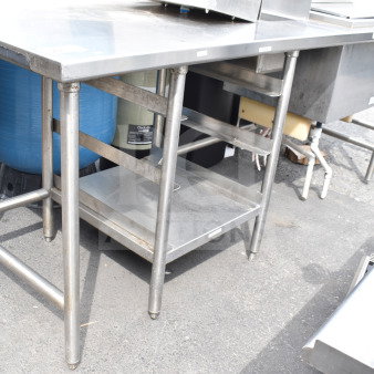 Commercial stainless steel table with integrated ice bin, durable construction, used condition, suitable for catering needs.