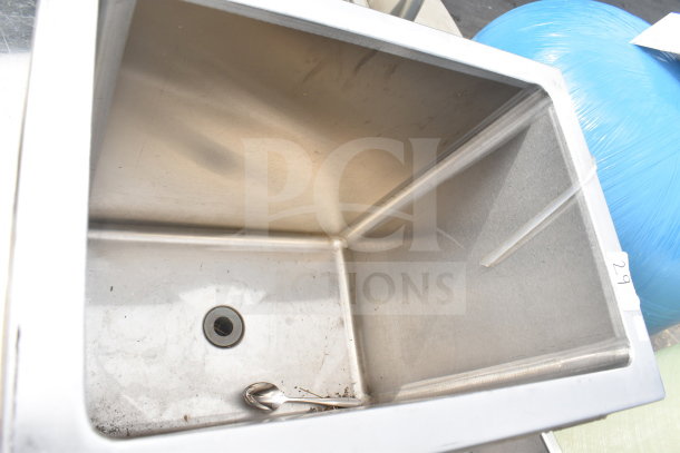 Stainless steel drop-in sink bay with drain. Slight signs of use, clean interior. Label marked "29" visible.