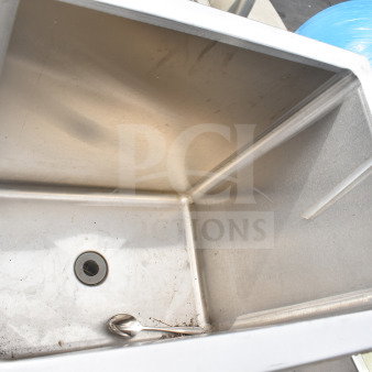 Stainless steel drop-in sink bay with drain. Slight signs of use, clean interior. Label marked "29" visible.