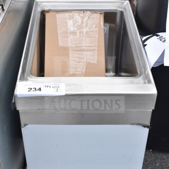 "Brand new Regency 600UHS2112 underbar hand sink with minor dents, 21x12 inches, with visible NSF label, stainless steel."