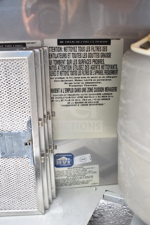 Best by Broan Hood with metal mesh filters, visible warning and cleaning instructions. Certified label present.