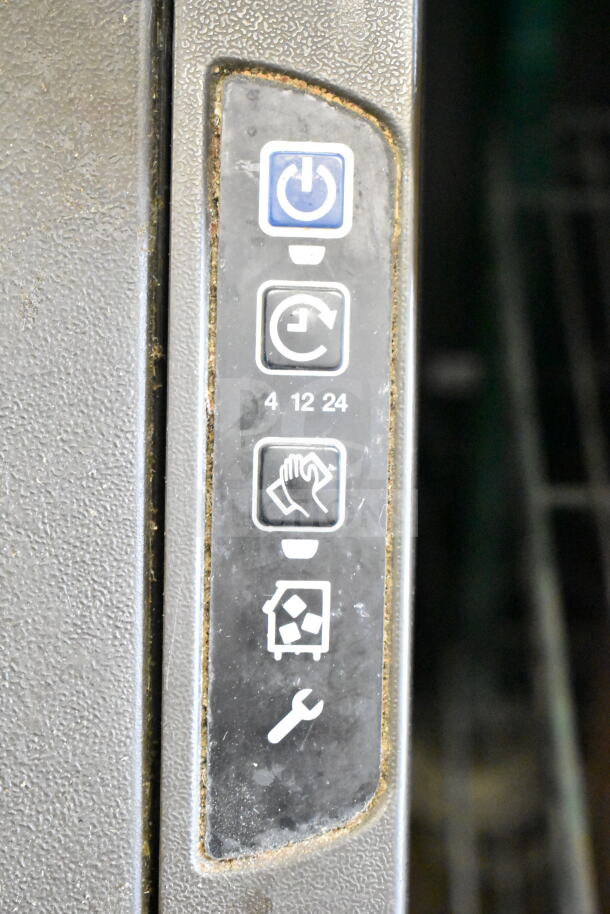 Control panel of a 2022 Manitowoc UYF0140A-161B Ice Machine, showing power and maintenance icons. Surface wear visible.