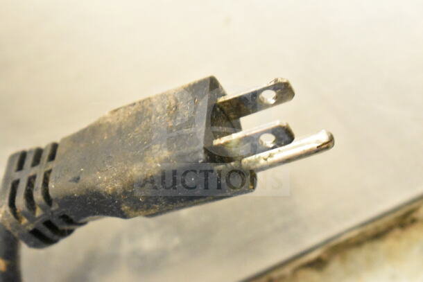 Close-up of the power plug for the 2022 Manitowoc UYF0140A-161B ice machine, showing slight wear and dirt.