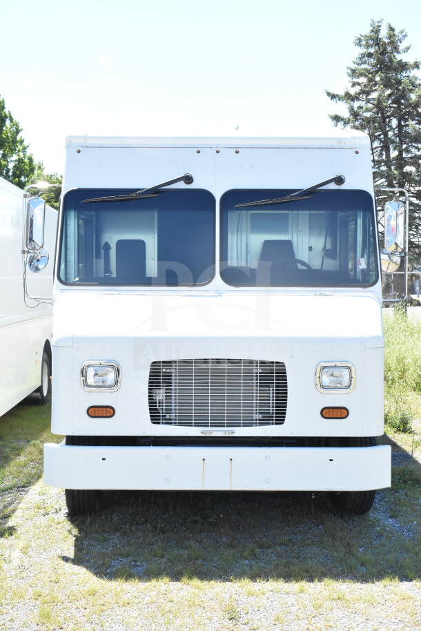 2021 Ford Step Van, front view. White exterior, VIN 1F66F5KN3M0A01361, good condition, dual windshield wipers, chrome side mirror.
