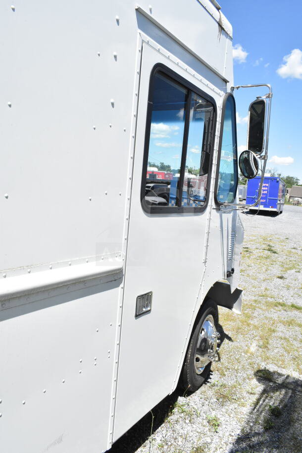 2021 Ford Step Van, VIN 1F66F5KN3M0A01361, white exterior, clean condition, side view with open driver door.