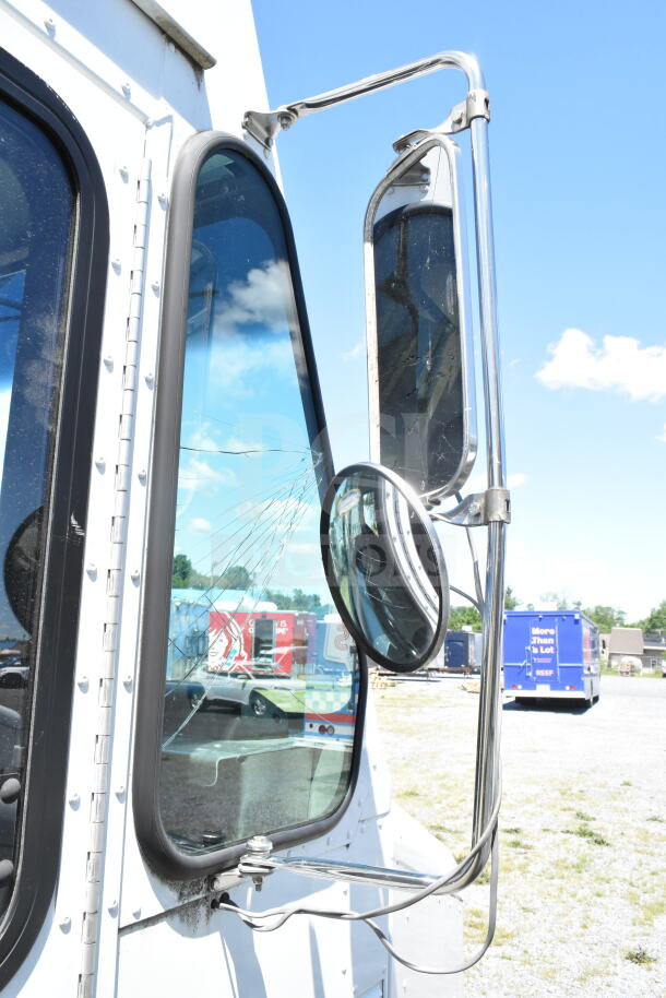 2021 Ford Step Van exterior mirror and cracked window, VIN 1F66F5KN3M0A01361, seen in outdoor setting.