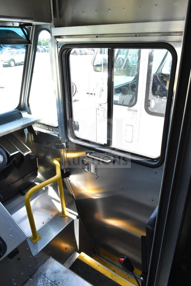 2021 Ford Step Van interior, showing driver's cabin with metal finish, yellow handrails, and side window, VIN 1F66F5KN3M0A01361.