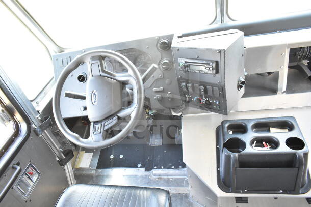 2021 Ford Step Van interior cockpit view, featuring a modern dashboard, steering wheel, and control panel. VIN 1F66F5KN3M0A01361.