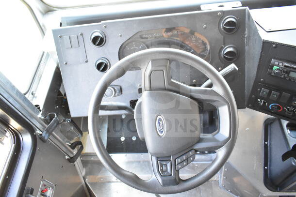 2021 Ford Step Van interior showing dashboard, steering wheel with Ford logo, and control panels. Clean condition.
