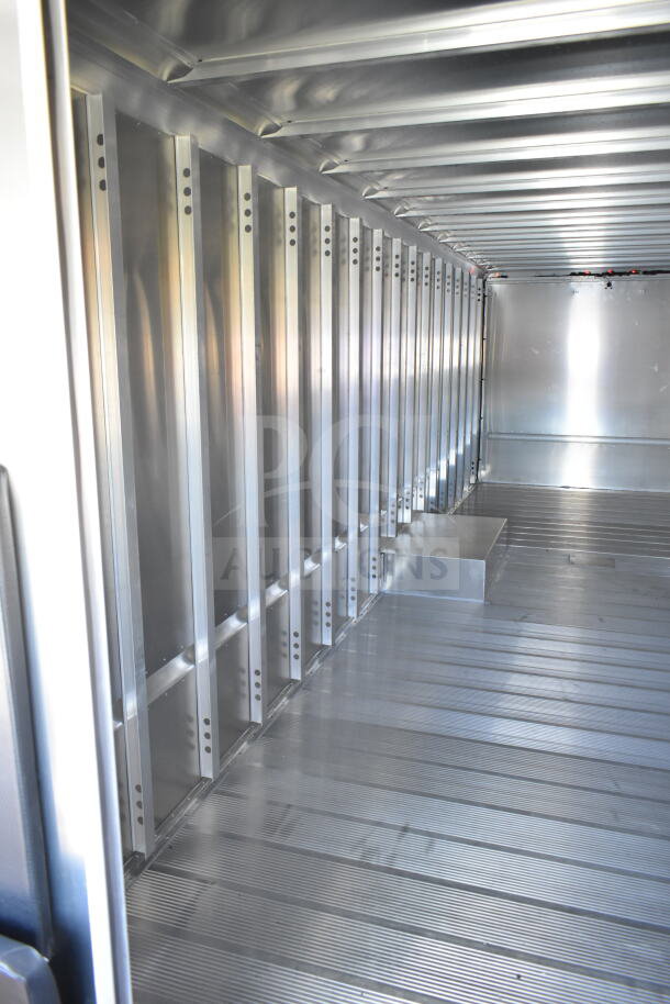 Interior view of 2021 Ford Step Van, showing empty aluminum cargo space in excellent condition, VIN 1F66F5KN3M0A01361.