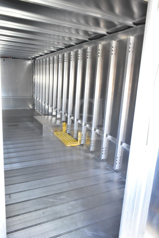 Interior of a 2021 Ford Step Van, showcasing clean, spacious metal panels and flooring, indicating excellent condition.