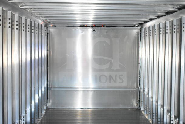 Interior of a 2021 Ford Step Van, showcasing a spacious, metallic cargo area with ribbed walls and ceiling. VIN 1F66F5KN3M0A01361.