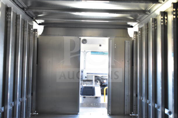 Interior view of 2021 Ford Step Van, showing metal paneling and cargo space. VIN 1F66F5KN3M0A01361.