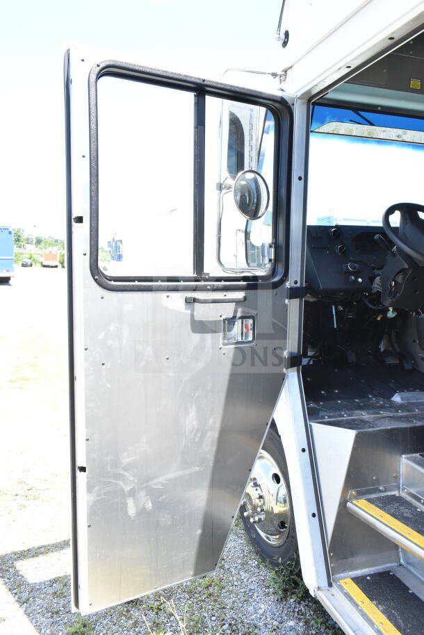 2021 Ford Step Van with open side door, metal interior, visible steering wheel, and rubber step treads. VIN 1F66F5KN3M0A01361.
