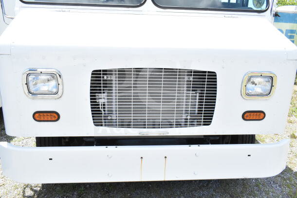 2021 Ford Step Van, front view close-up; white exterior, visible grill and headlights, VIN 1F66F5KN3M0A01361.