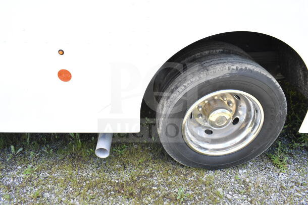 2021 Ford Step Van, side view showing rear tire and exhaust pipe, VIN 1F66F5KN3M0A01361, good condition.