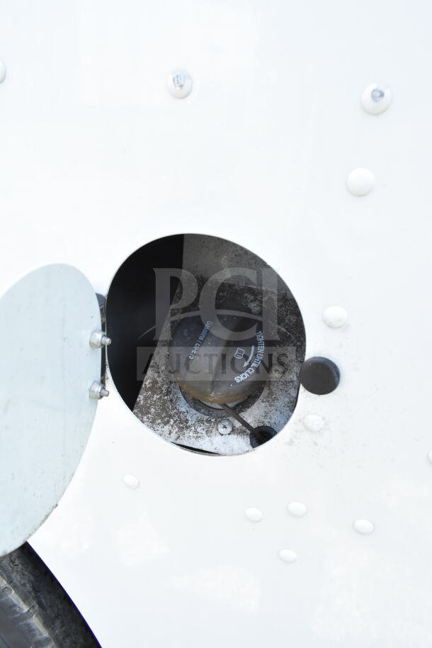 Fuel cap of a 2021 Ford Step Van, VIN 1F66F5KN3M0A01361, showing "Tighten Until Clicks" label, in good condition.