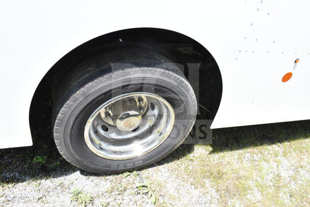 2021 Ford Step Van, close-up of rear Goodyear tire, chrome wheel, VIN 1F66F5KN3M0A01361, excellent condition.
