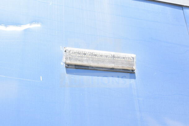 Close-up of light fixture on blue Southern Dimensions 8.5x28 cold beverage/food trailer.