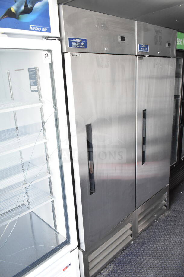 2020 Southern Dimensions 8.5x28 food trailer interior with Arctic Air commercial freezer and Turbo Air refrigerator. Visible shelving and labels.
