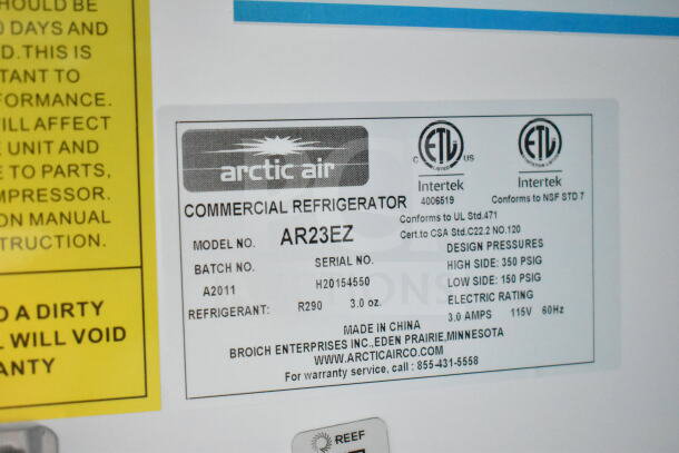 Label on Arctic Air commercial refrigerator, model AR23EZ, showing specifications, batch, refrigerant, and contact info.