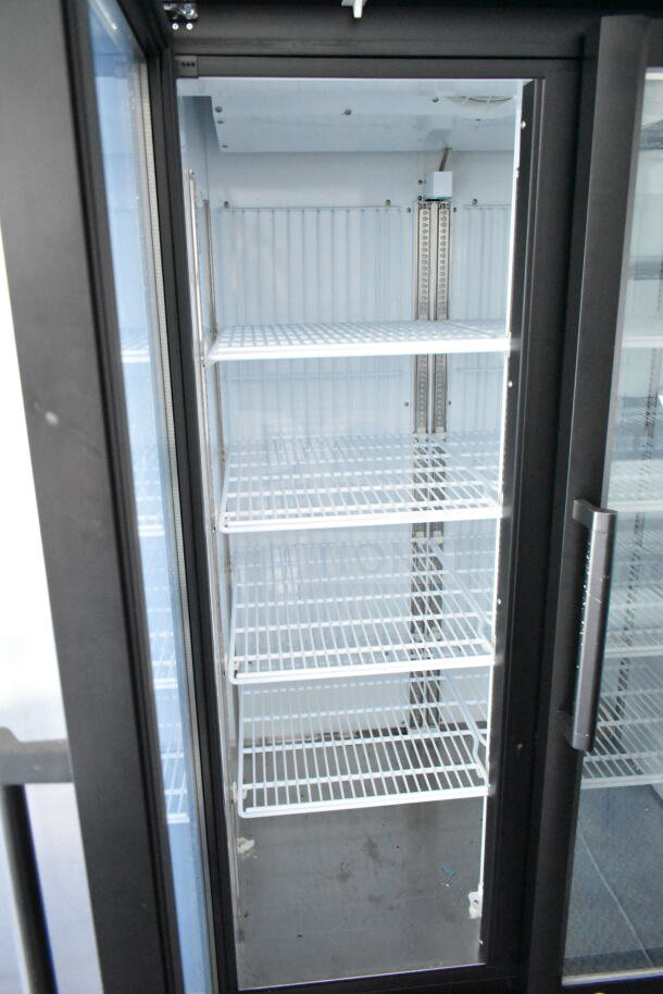 2020 Southern Dimensions 8.5x28 food trailer interior showing multiple white wire shelves inside a glass-door cooler.