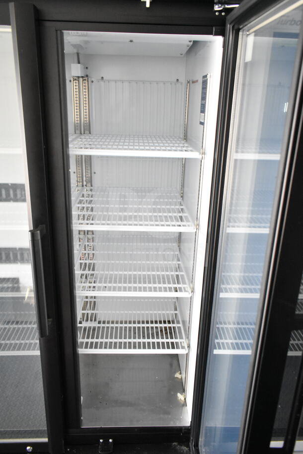 2020 Southern Dimensions 8.5x28 beverage trailer interior with empty shelving, cold storage unit, and glass door.