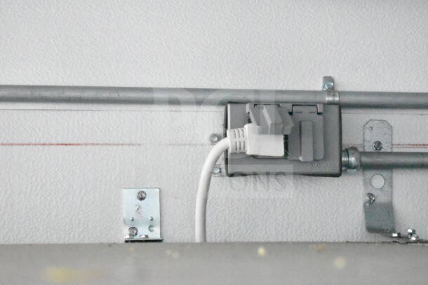 Outlet and power cable in Southern Dimensions 8.5x28 trailer. Secure mounting, part of electrical system.