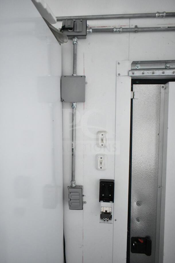 Interior of 2020 Southern Dimensions 8.5x28 cold beverage/food trailer showing electrical outlets and piping on wall.