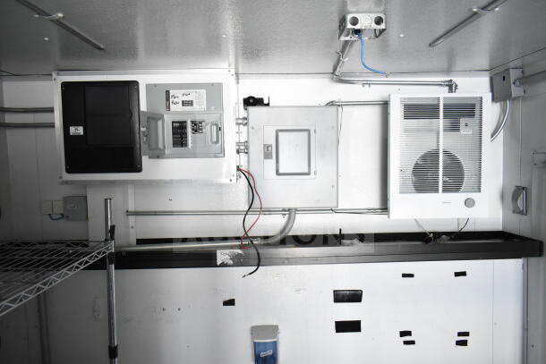 2020 Southern Dimensions 8.5x28 cold beverage/food trailer interior with coolers, freezers, electrical panel, and shelving.