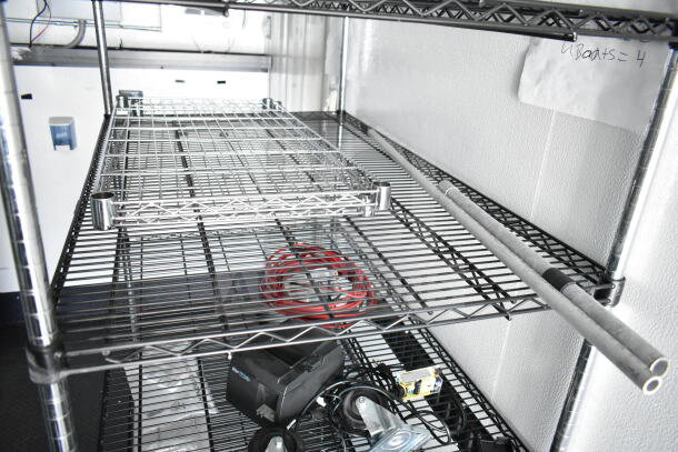 2020 Southern Dimensions 8.5x28 food trailer interior with metal shelving, electrical cables, and storage items.