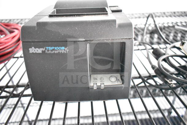 Star TSP100III futurePRNT thermal printer on a wire rack, with visible power cables. In good condition.